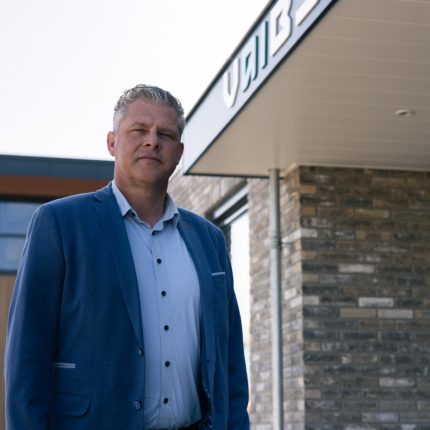 CEO standing in front of office.